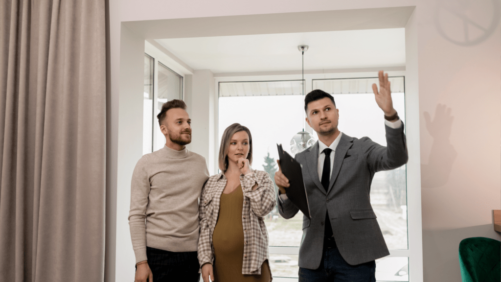 A couple attending an open house and discussing the property with their real estate agent for first time home buyers